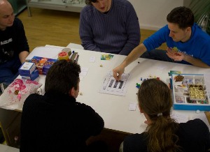 5 people playing a board game prototype